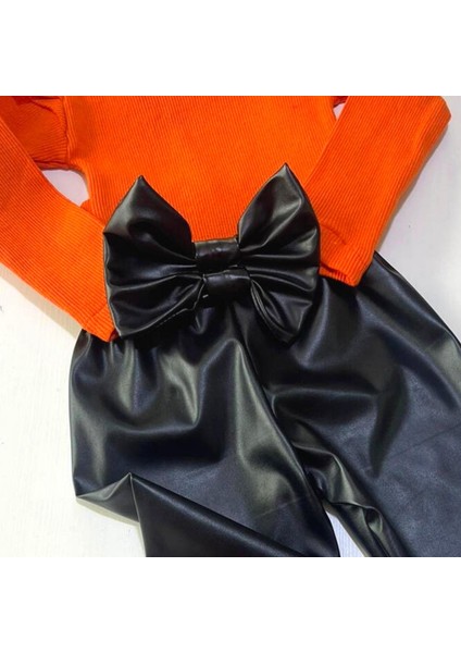 Kız Çocuk, Siyah Deri Fiyonk Detaylı Pantolon, Turuncu Omuzu Fırfırlı Badi ve Saç Bandı Takımı. fırsatları