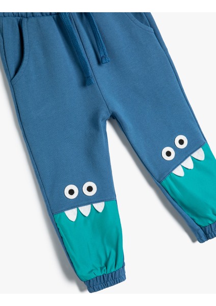 Jogger Eşofman Altı Beli Bağlamalı Canavar Baskılı Aplike Detaylı Pamuklu modelleri