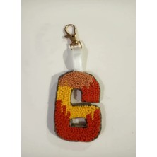 El Emeği Turuncu Sarı ve Kahverengi Tonlarında 6 Rakamı Şeklinde Anahtarlık