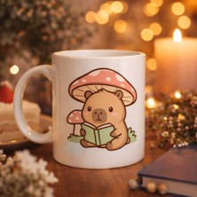 urfakent bilişim ve medya danışmanlık Sevimli Kitap Okuyan Kapibara Desenli Porselen Kupa Model 97 – Sıcacık Tasarım, Kahve & Çay Kupası, Hediye Fikri