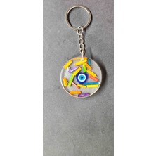 Miina Aksesuar Içerisinde Renkli Çiçekler ve Nazar Boncuğu Bulunan Şeffaf Epoksi Reçine ile Hazırlanmış Bir nazar Boncuklu Anahtarlıktır