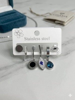 Nati Co Paslanmaz Çelik Küpe Kombini - Safir Mavisi Kristal Taşlı ve Işıltılı Nazar Gözü Detaylı Gümüş Renk Küpe Seti