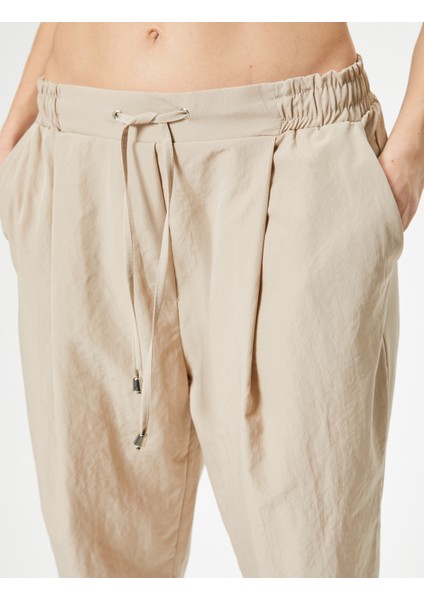 Paraşüt Pantolon Havuç Kesim Beli Bağcıklı Cep Detaylı indirimleri