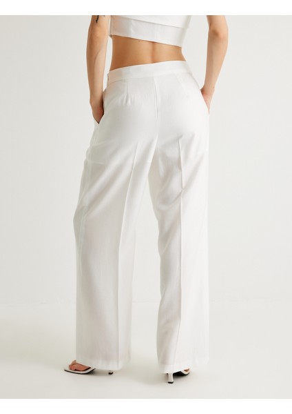 x Melis Ağazat - Geniş Paça Pantolon Tensel Kumaş Yarım Astarlı Pile Detaylı Cepli fırsatları