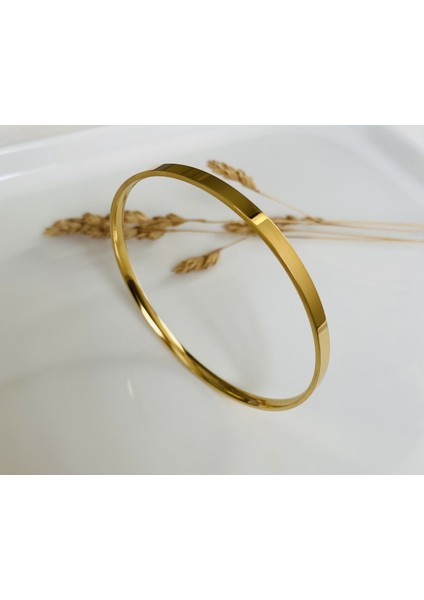 Altın tonlu sağlam çelik tek bilezik, şık ve dayanıklı aksesuar. fiyatları