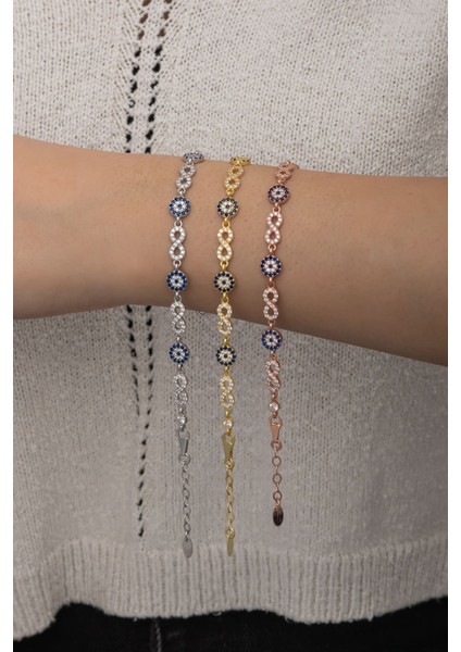 925 ayar gümüş bileklik, zirkon taşlı, pembe renk, nazar boncuğu ve sonsuzluk detaylı