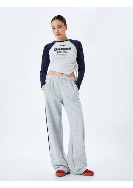 Uzun Reglan Kol Slim Fit Kolej Baskılı Büzgülü Asimetrik Crop Tişört fiyatları