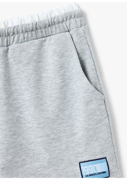 Çift Bel Detaylı Bağcıklı Etiket Baskılı Cepli Mini Spor Şort