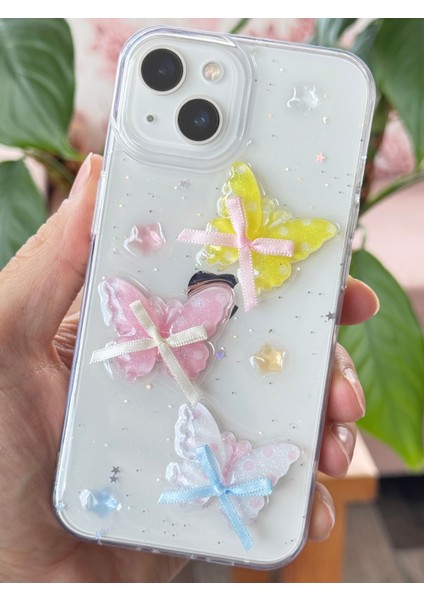 Apple iPhone 13 - 14 - 15 Kılıf Şeffaf Simli Renkli 3D Kelebek Desenli Fiyonk Kurdale Silikon Kapak