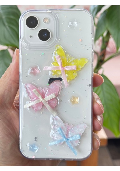 Apple iPhone 13 - 14 - 15 Kılıf Şeffaf Simli Renkli 3D Kelebek Desenli Fiyonk Kurdale Silikon Kapak