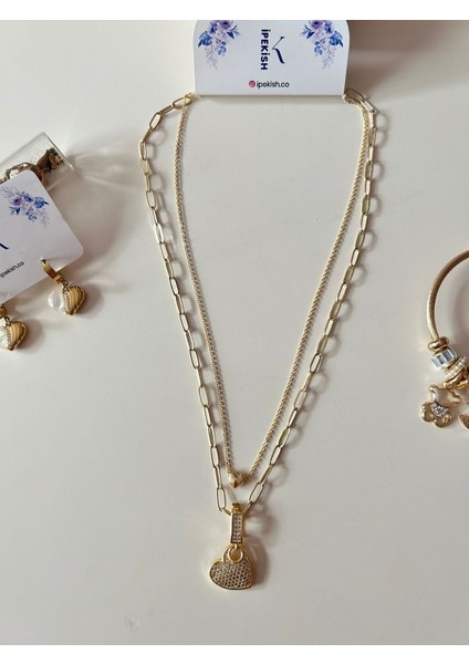 Gold Renk Paslanmaz Çelik Inci Boncuk Zincirli Kalp Sallantılı Kolye, Beyaz Zirkon Taşlı Kalp Sallantılı Çivi Küpe ve Kalp Detaylı Charm Bileklik 3’lü Set fırsatları