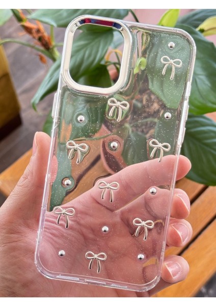 Apple iPhone 16 Plus Kılıf Fiyonk Desenli Şeffaf Simli Gümüş Kamera Çıkıntılı Parlak Kapak