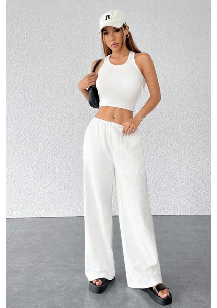 - Kadın Beyaz Bol Kesim Cepli Geniş Paça Dökümlü Pantolon modelleri