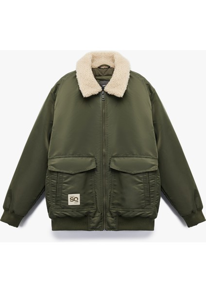 Uzun Kollu Cepli Etiket Detaylı Peluş Yaka Mont modelleri