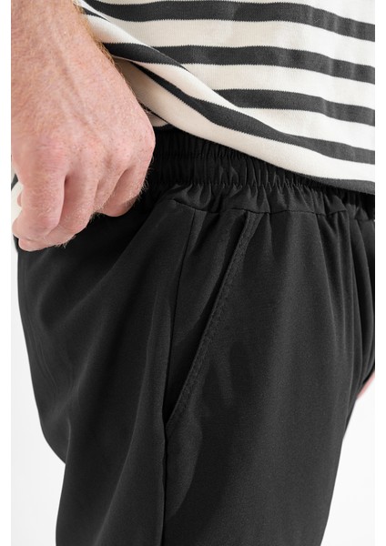 Erkek Siyah Likralı Esnek Ince Kumaş Lastikli Paça Torba Cep Pantolon