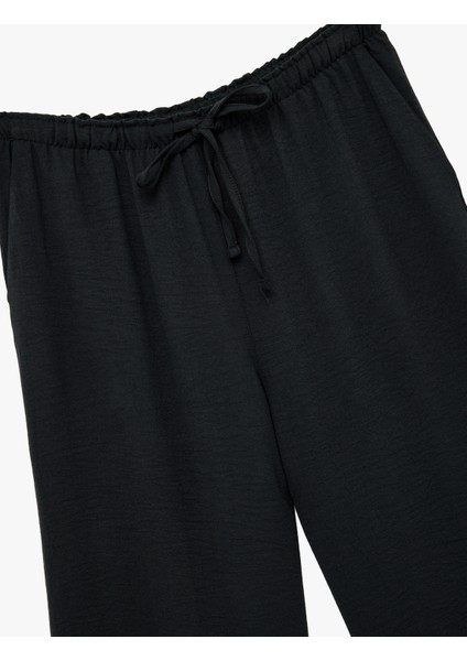 Rahat Kalıp Cep Detaylı Beli Bağcıklı Aerobin Kumaş Geniş Paça Pantolon indirimleri