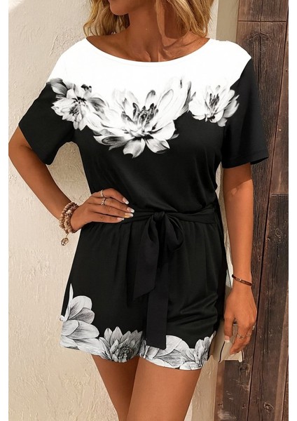 Kadın Tek Omuzu Açık Çiçek Desenli Beli Kuşaklı Iki Iplik Mini Short Tulum