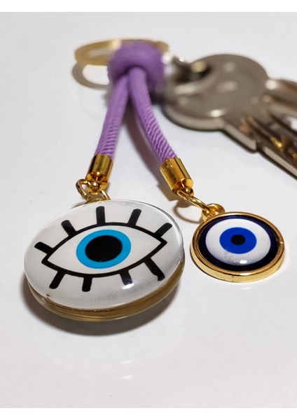 Göz Desenli Beyaz Cam Boncuk ve Küçük Sarı Metal Nazar Boncuklu Anahtarlık modelleri