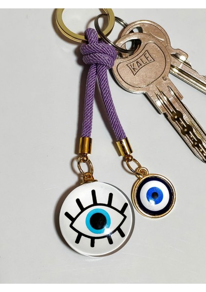 Göz Desenli Beyaz Cam Boncuk ve Küçük Sarı Metal Nazar Boncuklu Anahtarlık fırsatları