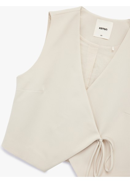 Viskon Karışımlı Slim Fit Bağlama Detaylı Crop Kruvaze Yaka Asimetrik Yelek modelleri