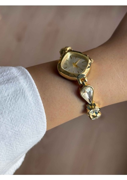 Beyaz Damla Taşlı Kordon Altın Renk Çelik Kadın Kol Saati -55 fiyatları