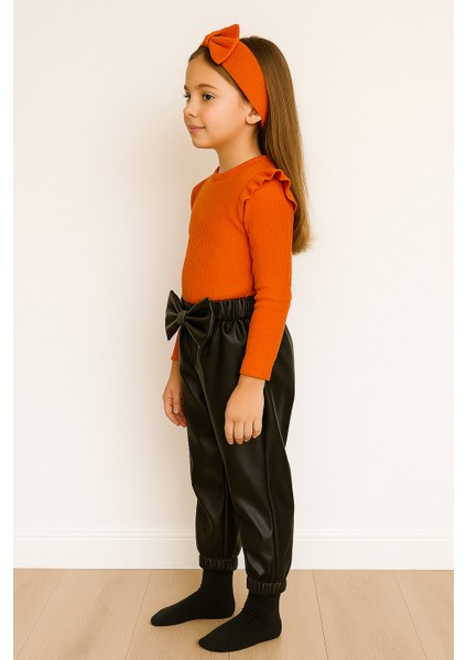 kız Çocuk, 3 Lü Set Siyah Deri Fiyonk Detaylı Pantolon, Turuncu Omuzu Fırfırlı Badi ve Saç Bandı Takımı.