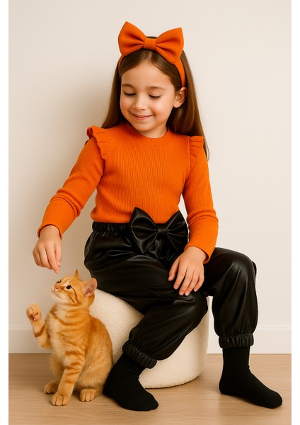 kız Çocuk, 3 Lü Set Siyah Deri Fiyonk Detaylı Pantolon, Turuncu Omuzu Fırfırlı Badi ve Saç Bandı Takımı. indirimleri