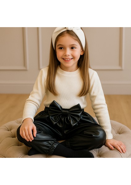 Kız Çocuk, Siyah Deri Fiyonk Detaylı Pantolon, Krem Omuzu Fırfırlı Badi ve Saç Bandı Takımı
