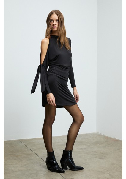 ASSETRA Kadın Yuvarlak Yakalı Esnek Kumaşlı Tek Omuzu Açık Bağlama Detaylı Mini Siyah Elbise fiyatları