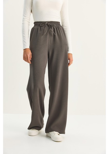 Kadın Yüksek Bel Lastikli Bağcıklı Dökümlü Bol Paça Pantolon indirimleri