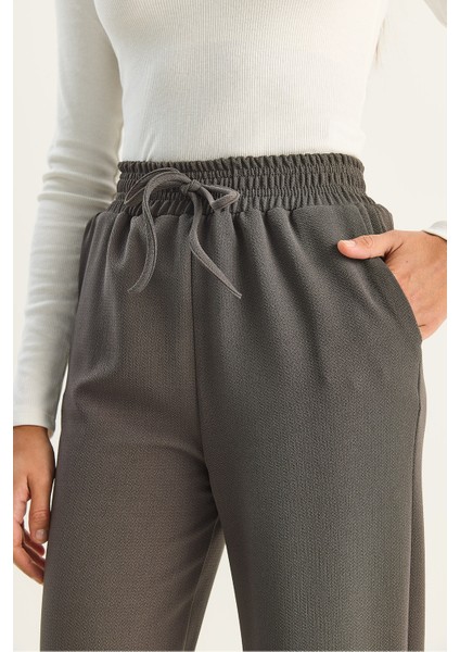 Kadın Yüksek Bel Lastikli Bağcıklı Dökümlü Bol Paça Pantolon