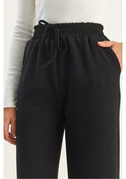 Kadın Yüksek Bel Lastikli Bağcıklı Dökümlü Bol Paça Pantolon