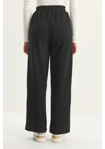 Kadın Yüksek Bel Lastikli Bağcıklı Dökümlü Bol Paça Pantolon