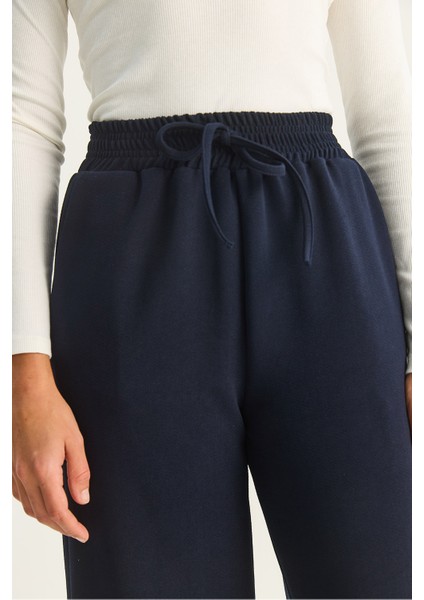 Kadın Yüksek Bel Lastikli Bağcıklı Dökümlü Bol Paça Pantolon