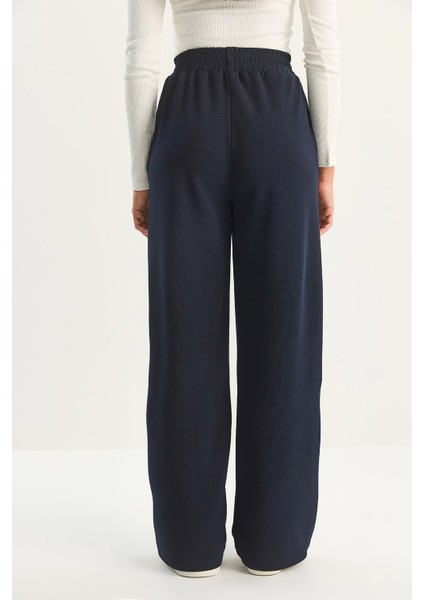 Kadın Yüksek Bel Lastikli Bağcıklı Dökümlü Bol Paça Pantolon