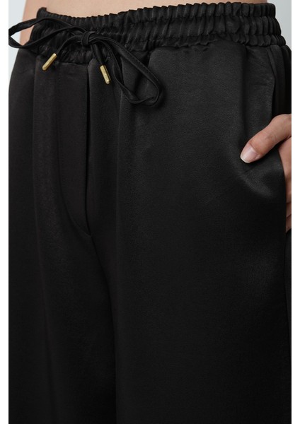 Kadın Düz Renk Parlak Kumaş Bol Paça Beli Lastikli Pantolon fırsatları