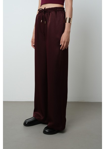Kadın Düz Renk Parlak Kumaş Bol Paça Beli Lastikli Pantolon fiyatları