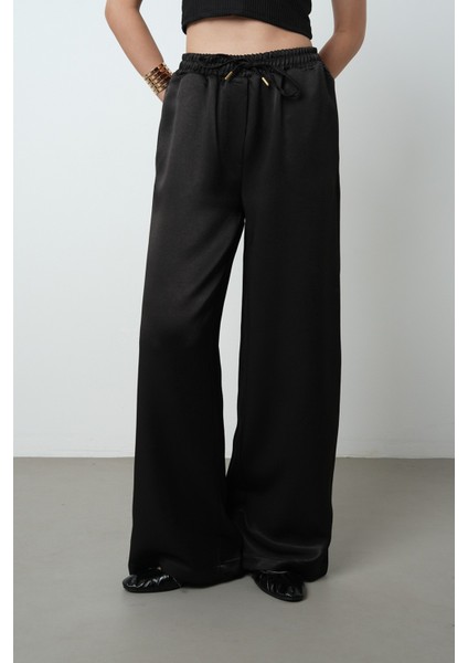 Kadın Düz Renk Parlak Kumaş Bol Paça Beli Lastikli Pantolon fiyatları