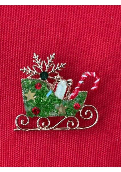 Yeşil Renkli ve Parlak Taşlı Yılbaşı Kızak Figürlü Gold Broş fiyatları